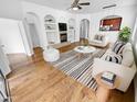 Bright living room with hardwood floors, modern furnishings, and a cozy fireplace, perfect for entertaining at 6617 W Cavedale Dr, Phoenix, AZ 85083