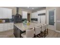Spacious kitchen with a large island, modern appliances, custom cabinetry, and a decorative backsplash at 6621 E Oberlin Way, Scottsdale, AZ 85266