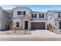 Charming two-story home featuring a stone entrance, dark shutters, and a spacious two-car garage at 7420 S 76Th Ln, Laveen, AZ 85339