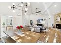 Bright living room with hardwood floors, fireplace, vaulted ceilings, modern lighting, and stylish decor at 8405 E San Pedro Dr, Scottsdale, AZ 85258