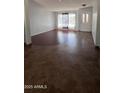 Inviting living room with hardwood flooring and large window, offering a bright and airy feel at 8618 N 45Th Dr, Glendale, AZ 85302