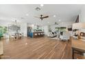 Open-concept living space with hardwood floors, modern kitchen, and comfortable seating area at 8701 E Sage Dr, Scottsdale, AZ 85250