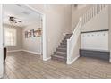Welcoming entryway featuring a staircase, a coat rack, and wood-look tile flooring at 9764 E Radioactive Dr, Mesa, AZ 85212