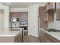 Bright kitchen featuring an island, stainless steel appliances, wood cabinetry, and tiled backsplash at 9775 S 36Th Ln, Laveen, AZ 85339
