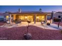 Spacious covered patio perfect for entertaining, complete with ample seating, a grill, and desert landscaping at 12928 W Santa Ynez Dr, Sun City West, AZ 85375