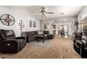 Spacious living room featuring comfortable seating, an open layout, and seamless flow to dining area at 13359 W Post Dr, Surprise, AZ 85374
