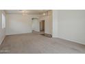 Spacious living room with neutral carpet, chandelier lighting, and doorway views to other rooms at 1726 E Primera Dr, Casa Grande, AZ 85122