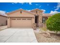 Beautiful single story home with a two car garage, red tile roof, stone accents, and desert landscaping at 17907 W Cedarwood Ln, Goodyear, AZ 85338