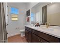 Bathroom featuring double vanity sinks and modern fixtures, offering a stylish and functional design at 18534 W Mohave St, Goodyear, AZ 85338