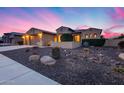 Charming home with desert landscaping, a three-car garage, and inviting curb appeal at 19414 W Pasadena Ave, Litchfield Park, AZ 85340