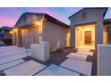 Well-maintained home featuring desert landscaping and a welcoming entrance with stone accents at 19414 W Pasadena Ave, Litchfield Park, AZ 85340