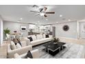 Bright, open-concept living room and kitchen area with sleek modern furniture and stainless steel appliances at 2006 N Arrowhead Dr, Chandler, AZ 85224