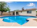 Beautiful in-ground pool with patio, fence, and view of house exterior at 2006 N Arrowhead Dr, Chandler, AZ 85224