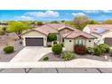 An aerial view showcasing the home's roof, spacious driveway, lush landscaping, and surroundings at 20642 N 268Th Dr, Buckeye, AZ 85396