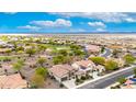 Aerial view of homes with tile roofs and solar panels throughout a community with desert landscaping at 20642 N 268Th Dr, Buckeye, AZ 85396
