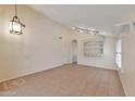 Spacious living room with neutral walls, tile flooring, high ceilings and modern track lighting at 2312 E Williams Dr, Phoenix, AZ 85024