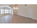 Open living area featuring tile floors, multiple windows for natural light, and vaulted ceilings at 2312 E Williams Dr, Phoenix, AZ 85024