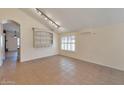 Bright living room with tile flooring, built in shelves, and ample space for entertaining at 2312 E Williams Dr, Phoenix, AZ 85024