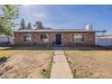 Charming single-story brick home with a well-maintained front yard and walkway at 3107 W Tuckey Ln, Phoenix, AZ 85017