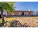 Charming single-story brick home with a well-maintained front yard at 3107 W Tuckey Ln, Phoenix, AZ 85017