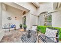 Comfortable front porch area, featuring a decorative door, outdoor seating, and manicured plants at 3440 E Topeka Dr, Phoenix, AZ 85050