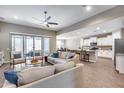 Bright living room open to kitchen with tile floors, plush seating and ample natural light at 35773 N Loemann Dr, San Tan Valley, AZ 85143