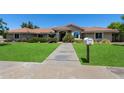 Inviting single-story home boasting a well-manicured front lawn, desert landscaping, and a charming walkway at 3822 E Florian Ave, Mesa, AZ 85206