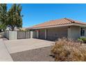 Spacious three-car garage with a red tile roof and gated access, offering ample parking and privacy at 3822 E Florian Ave, Mesa, AZ 85206
