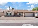 Charming single-story home featuring desert landscaping, attached two-car garage, and neutral color palette at 4107 W Mariposa Grande --, Glendale, AZ 85310