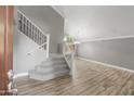 Bright entryway features tile flooring, staircase with wrought iron spindles, and views into open living space at 4226 E Stanford Ave, Gilbert, AZ 85234