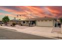 Inviting single-story brick home with desert-style landscaping, two-car garage and palm trees at 4655 E Farmdale Ave, Mesa, AZ 85206
