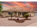 Well-maintained single-story brick home boasts xeriscaping, cacti and a welcoming front porch at 4655 E Farmdale Ave, Mesa, AZ 85206