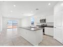 Bright kitchen featuring an island, granite countertops, and stainless steel appliances at 469 W Bunker Hill St, Florence, AZ 85132