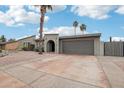 Contemporary home with desert landscaping, a two-car garage, and a neutral-colored exterior at 5119 E Shaw Butte Dr, Scottsdale, AZ 85254