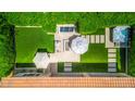 Stunning aerial view of the backyard featuring a manicured yard, spa, pool and outdoor seating at 5542 E Alan Ln, Paradise Valley, AZ 85253