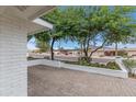 Cozy courtyard with brick pavers, a low brick wall, and views of the surrounding neighborhood at 6019 E Windsor Ave, Scottsdale, AZ 85257