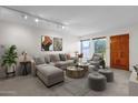 Bright living room featuring a large sectional sofa and stylish decor at 7319 E Northland Dr # 5, Scottsdale, AZ 85251
