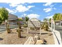 Community entrance signage with desert landscaping, rocks and cacti at 7474 E Earll Dr # 311, Scottsdale, AZ 85251