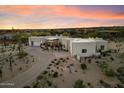 Aerial view of a desert home showcasing lush desert landscaping and neutral exterior with a brick driveway at 9022 E Diamond Rim Dr, Scottsdale, AZ 85255