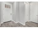 Bright entryway featuring white doors, neutral walls and stylish gray wood-look flooring at 10352 E Sebring Ave, Mesa, AZ 85212