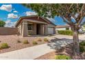 Inviting single-Gathering home featuring desert landscaping, covered entryway and attached garage at 10352 E Sebring Ave, Mesa, AZ 85212