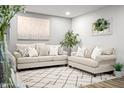 Cozy living room with two couches, an area rug, and decor providing a comfortable, welcoming space at 10617 W Daley Ln, Peoria, AZ 85383