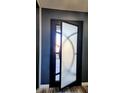 A stylish front door with unique frosted glass and dark trim detail adds a modern touch to the home's entry at 10738 W Rowel Rd, Peoria, AZ 85383