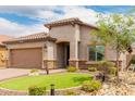 Inviting single-story home with tiled roof, neutral stucco, stone accents, and well-maintained landscaping at 10738 W Rowel Rd, Peoria, AZ 85383