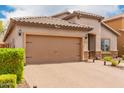 Charming single-story home featuring a tiled roof, neutral stucco, brick driveway, and well-kept bushes at 10738 W Rowel Rd, Peoria, AZ 85383