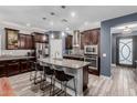 Spacious kitchen with large island, granite countertops, stainless appliances, and dark wood cabinetry at 10738 W Rowel Rd, Peoria, AZ 85383