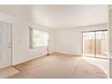 Bright living room with a large window and sliding doors to the patio at 1208 E Lawrence Ln, Phoenix, AZ 85020