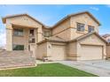 Charming two-story home featuring a 2-car garage, low maintenance landscaping, and neutral color palette at 13304 W Stella Ln, Litchfield Park, AZ 85340