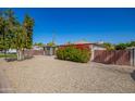 Home with mature trees and a low maintenance desert landscape in the front yard at 1334 W Sells Dr, Phoenix, AZ 85013