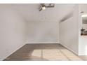 Open living room with ceiling fan and light wood-look flooring at 13521 E Butler St, Chandler, AZ 85225